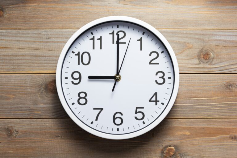 wall clock at wooden background